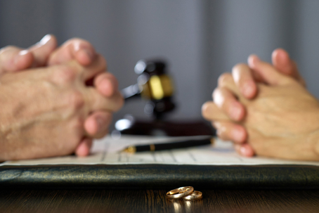 couple facing each other before signing divorce papers