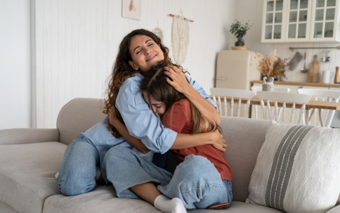 mom hugging daughter