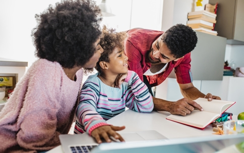 parents heling child with homework